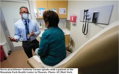  ?? ?? Nurse practition­er Anthony Carano speaks with a patient at the Mountain Park Health Center in Phoenix. Photo: AP/Matt York.