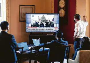  ?? Erin Schaff / New York Times ?? Several of the House impeachmen­t managers, including Rep. Joaquin Castro, center, watch the prosecutio­n’s display of videos during the second impeachmen­t trial of Donald Trump.