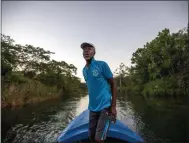 ?? DAVID GOLDMAN ?? White River Fish Sanctuary warden and diver Everton Simpson heads out to sea to patrol against illegal fishing at dawn in White River, Jamaica, Tuesday, Feb. 12, 2019. Once a spear fisherman and later a scuba-diving instructor, Simpson started working as a “coral gardener” and warden two years ago, part of grassroots efforts to bring Jamaica’s coral reefs back from the brink.