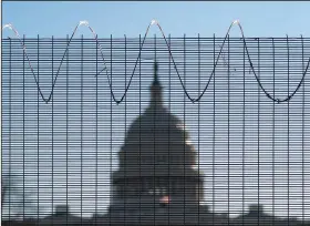  ?? (AP/J. Scott Applewhite) ?? Fencing topped with razor wire surrounds the U.S. Capitol in Washington on Thursday.