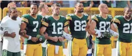  ?? ADAM WESLEY/USA TODAY NETWORK-WISCONSIN ?? Packers players link arms during the national anthem before their game on Sunday at Lambeau Field.