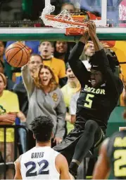  ?? Tony Gutierrez / Associated Press ?? Baylor’s Johnathan Motley rattles the rim on a dunk in the first half. Motley had 17 points and eight rebounds in the Bears’ 76-61 victory over Xavier.