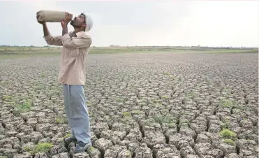  ??  ?? IT GETS WORSE BEFORE IT GETS BETTER: In this May 10, 2016, photo, a man drinks water on the dry bed of the Manjara Dam in Marathwada. Water levels at the 91 large reservoirs have fallen to an abysmal 15% of their combined installed capacity