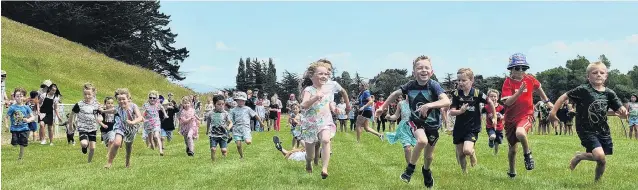  ?? PHOTO: CHRISTINE O’CONNOR ?? Runners race for glory during a children’s event at yesterday’s Waikouaiti races. More from the races