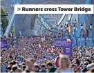  ?? ?? > Runners cross Tower Bridge