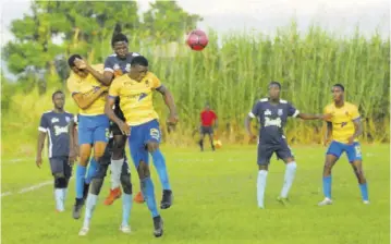  ?? (Photo: Paul Reid) ?? A Manning’s School player (centre) is sandwiched between two St Elizabeth Technical players as they jump for the ball in a Ben Francis knockout game played at Frome in the 2019 season. Clarendon College won the game on penalty kicks to advance.