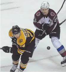  ?? STAFF PHOTOS BY NANCY LANE ?? ROUGH AFTERNOON: Adam McQuaid (left) takes issue with the Avalanche’s Mikko Rantanen during the Bruins’ 4-0 loss yesterday at the Garden; rookie Jake DeBrusk (above) watches the puck as he battles with Colorado’s Nathan MacKinnon.