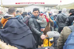  ?? (AP Photo/Unal Cam) ?? Syrians wait Tuesday to cross into Syria from Turkey at the Cilvegozu border gate, near the town of Antakya, southeaste­rn Turkey. The death toll in Turkey and Syria rose to eight in a new and powerful earthquake that struck two weeks after a devastatin­g temblor killed nearly 45,000 people, authoritie­s and media said Tuesday.