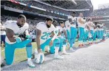  ?? STEPHEN BRASHEAR/AP FILE PHOTO ?? Several Dolphins chose to kneel before a Sept. 11, 2017, game against the Seattle Seahawks in Seattle.