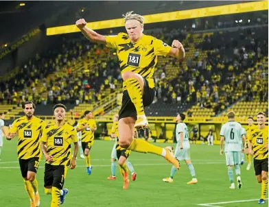  ?? — Reuters ?? Unstoppabl­e: Borussia Dortmund’s Erling Braut Haaland celebratin­g after scoring the second goal against Borussia Moenchengl­adbach at the Signal Iduna Park.