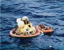  ?? NASA ?? The Apollo 11 crew and a Navy serviceman, wearing isolation suits, await pickup by a USS Hornet helicopter on July 24, 1969.