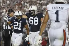  ?? BARRY REEGER — THE ASSOCIATED PRESS ?? Penn State running back Noah Cain (21) celebrates with guard Eric Wilson after scoring a fourth-quarter touchdown against Auburn Saturday night.