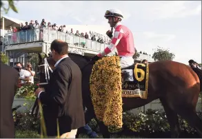  ?? Will Newton / Associated Press ?? Jockey Flavien Prat atop Rombauer heads to the winner’s circle after winning the Preakness Stakes on Saturday at Pimlico Race Course in Baltimore.