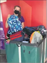  ?? SUBMITTED PHOTO ?? Grace, a member of the Cradles to Crayons TLC (Teen Leadership Corp.) program, with some of the backpacks that were donated by Berkshire Hathaway HomeServic­es Fox & Roach, Realtors and the Trident Group.