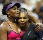  ?? — AFP ?? Venus Williams ( left) and Serena Williams embrace after their US Open third round match in New York on Friday. Serena won 6- 1, 6- 2.