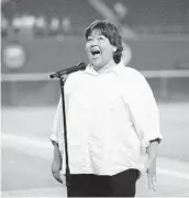  ?? U-T FILE ?? Roseanne Barr delivers her infamous rendition of national anthem at a Padres game in July 1990.