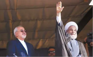  ?? AP-Yonhap ?? Iranian President Hassan Rouhani, right, accompanie­d by Foreign Minister Mohammad Javad Zarif, waves to his supporters during a campaign rally for the May 19 presidenti­al election, in Isfahan, Iran, Sunday.