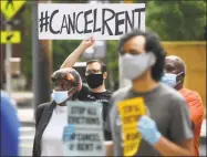  ?? Brian A. Pounds / Hearst Connecticu­t Media ?? Members of the Cancel Rent Coalition and residents attend the Elm City Communitie­s/Housing Authority announceme­nt of the cancellati­on of July rent during a press conference outside McQueeney Towers in New Haven on June 18.