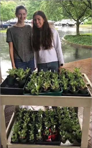  ?? SUBMITTED PHOTO ?? Souderton Area High School students Lauren McClure and Peyton Krebs deliver “Flower Power” plants to Living Branches Souderton Mennonite Homes campus.