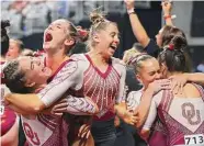  ?? Gareth Patterson / Associated Press ?? The Oklahoma Sooners celebrate their victory in the women's gymnastics championsh­ips on Saturday.