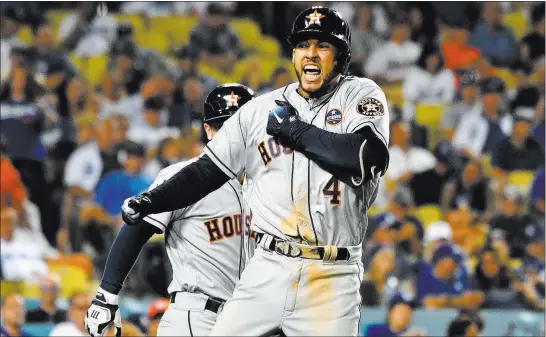  ?? Richard Mackson ?? George Springer hit a two-run homer in the 11th – one of eight HRS to set a single-game World Series record – as the Astros downed the Dodgers in Game 2. USA Today