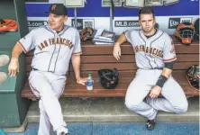  ?? Rob Tringali / MLB Photos via Getty Images ?? The Giants’ Buster Posey (right) said he had a “good idea” that manager Bruce Bochy (left) was planning to step down.