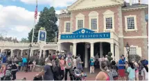  ?? DEWAYNE BEVIL/ ORLANDO SENTINEL ?? Magic Kingdom visitors stroll past The Hall of Presidents in late 2017.