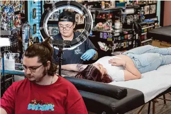  ?? Laure Andrillon/Special to the Chronicle ?? Tattoo artist Jin Kin inks Leilani Ysalgue, 22, as Pastime Tattoo in San Leandro takes part in Still Not Asking For It, a national event raising awareness and money to support survivors of sexual violence.