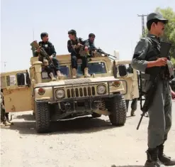  ?? —AFP ?? HELMAND: Afghan security personnel sit on atop an armored vehicles amid an ongoing battle with Taleban militants in the Gereshk district.