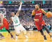  ?? MADDIE MEYER/GETTY IMAGES ?? Miami’s Wayne Ellington evades Terry Rozier (12) of Boston during the second quarter Wednesday night. A rate switch to a zone on defense helped Ellington and the short-handed Heat pull off the upset.