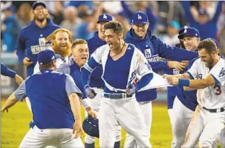  ?? Gina Ferazzi Los Angeles Times ?? CODY BELLINGER did not mind literally losing his shirt after his single in the bottom of the 13th lifted the Dodgers to a win that tied the series. Bellinger would be named series MVP.