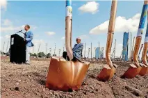  ??  ?? Mayor Mick Cornett, left, and Tom McDaniel participat­e in a ceremonial groundbrea­king Thursday to mark the beginning of constructi­on of the MAPS 3 “Scissortai­l Park” downtown in front of Union Station in Oklahoma City.