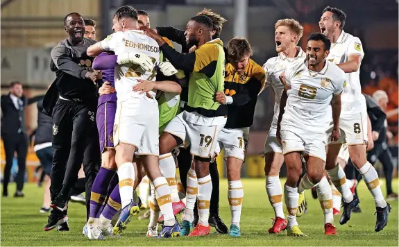  ?? ?? WINNING FEELING: Port Vale players celebrate beating Swindon on penalties to book their place in the League Two play-off final at Wembley.