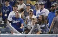  ?? MARK J. TERRILL - THE ASSOCIATED PRESS ?? Boston Red Sox third baseman Eduardo Nunez falls into the stands after catching a foul ball hit by Los Angeles Dodgers’ Cody Bellinger during the 13th inning in Game 3 of the World Series baseball game on Friday, Oct. 26, 2018, in Los Angeles.