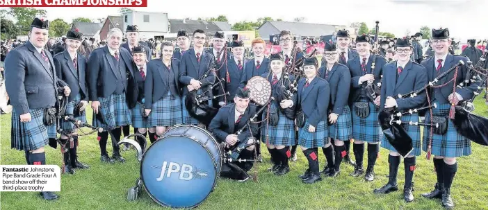  ??  ?? Fantastic Johnstone Pipe Band Grade Four A band show off their third-place trophy