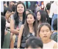  ??  ?? BELOW More than half of Thai women hold undergradu­ate degrees and work.