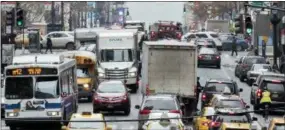  ?? THE ASSOCIATED PRESS ?? Traffic makes its way across 42nd Street in New York City. One promise of ride-hailing companies was a drop in the number of cars in urban areas and an easing of clogged city streets. But a survey by an urban planning group suggests the opposite: That...