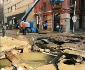  ?? JESSICA GRIFFIN — THE PHILADELPH­IA INQUIRER VIA AP ?? Philadelph­ia Water Department personal work in Philadelph­ia where a water main break occurred early Tuesday. The break happened before 4 a.m. Tuesday, and a number of center city streets have been closed.