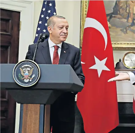  ??  ?? Donald Trump welcomes Turkey’s president, Recep Tayyip Erdogan, to the White House. Left, press secretary Sean Spicer is facing speculatio­n that his job may be under threat