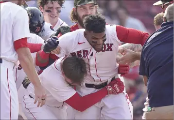  ?? STEVEN SENNE – THE ASSOCIATED PRESS ?? The Red Sox’s Franchy Cordero, center, celebrates his winning grand slam in the 10th inning against the Mariners on Sunday.