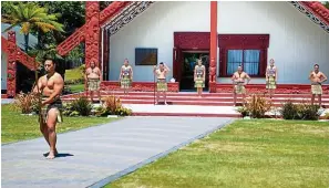  ?? — BOB McCREE/ New Zealand Tourism ?? As per traditiona­l Maori culture, visitors at Te Puia are welcomed to the marae
(tribal meeting place) only after taking part in the powhiri .