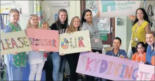  ??  ?? LOOKING UP: The team of intrepid skydivers from Hillingdon Hospital are raising cash for equipment at the Peter Pan Ward