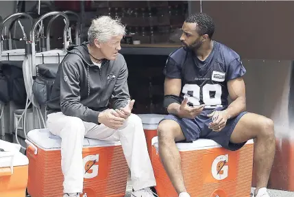  ?? AP ?? Seattle Seahawks wide receiver Doug Baldwin (right) talks with head coach Pete Carroll following training on Thursday in Renton, Washington.