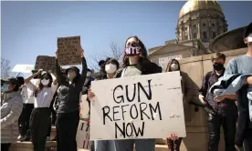  ??  ?? A woman advocates for stricter gun reform laws at a rally at the Georgia state capitol in the wake of the shootings at three spas in Atlanta. Photograph: Robin Rayne/Zuma Wire/Rex/ Shuttersto­ck