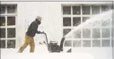  ?? Catherine Avalone / Hearst Connecticu­t Media ?? Middletown resident Matthew Soloman uses his snowblower to clear his driveway during the first blizzard of the year on Thursday.