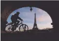  ?? REUTERS ?? A MAN rides a bicycle along a bike path on the Pont de Bir-Hakeim bridge near the Eiffel Tower in Paris, France, Jan. 19.
