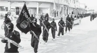  ?? THE ASSOCIATED PRESS FILES ?? Fighters from the al-Qaida linked Islamic State of Iraq and the Levant march in Raqqa, Syria. Old allegiance­s and hatreds
have surfaced in recent years in the Middle East resulting in groups claiming various territorie­s.