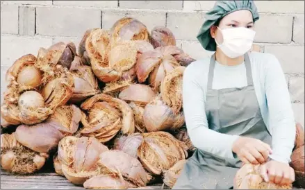  ?? SUPPLIED ?? Today Phka Doung uses three teams of workers to process the coconuts from peeling coconut husks to filtering the oil.