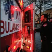  ?? JOHN MINCHILLO / ASSOCIATED PRESS FILE (2020) ?? Paramedic Alex Tull, having recently recovered from COVID-19, prepares to begin his shift April 23, 2020, outside EMS station 26, the “Tinhouse,” in the Bronx borough of New York.