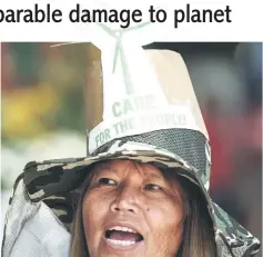  ??  ?? A protester takes part in a march to the Department of Environmen­t and Natural Resources (DENR) in Manila. — AFP photos